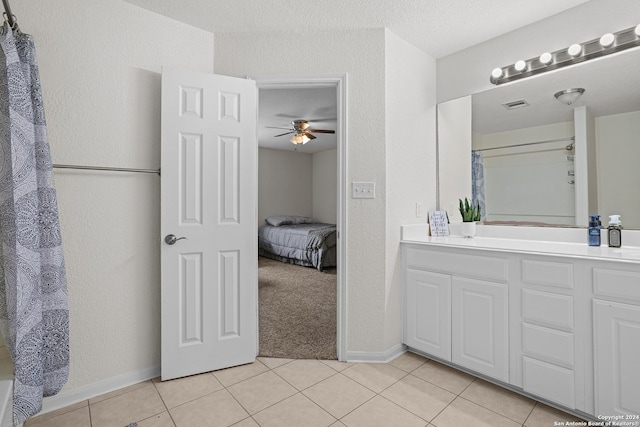 bathroom featuring tile patterned floors, ceiling fan, and vanity