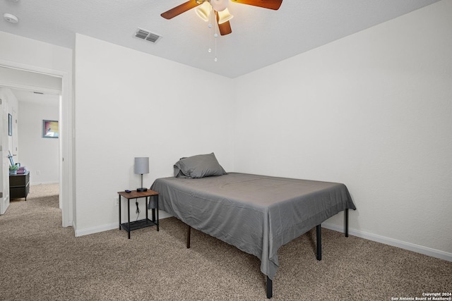 bedroom with ceiling fan and light carpet