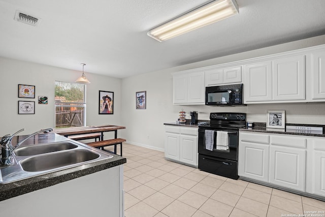 kitchen featuring a textured ceiling, sink, black appliances, white cabinets, and light tile patterned flooring