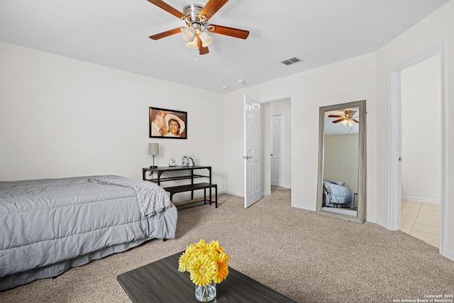 bedroom with ceiling fan and light carpet