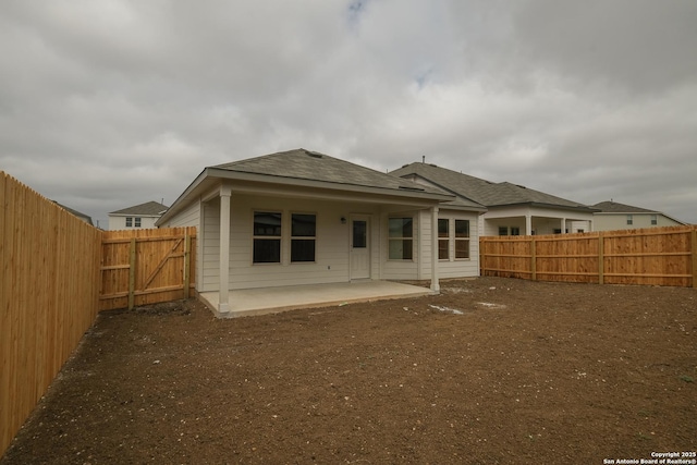 back of house featuring a patio and a fenced backyard