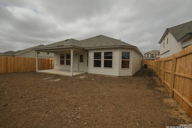 rear view of property with a patio area, central AC unit, and a fenced backyard