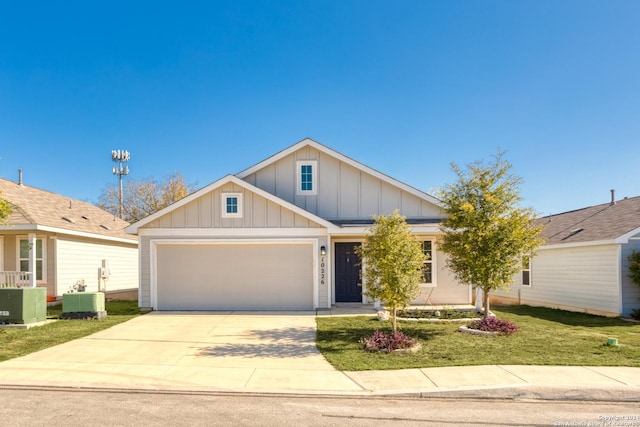 view of front of property featuring central AC unit and a garage