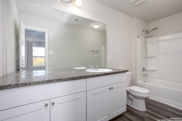 full bathroom with toilet, wood-type flooring, vanity, and bathing tub / shower combination