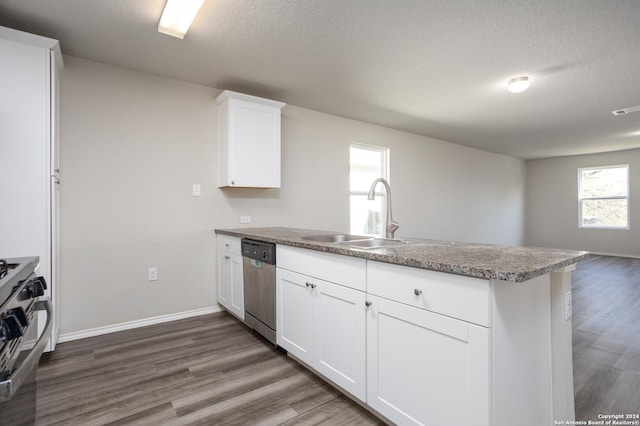 kitchen featuring kitchen peninsula, white cabinetry, sink, and stainless steel appliances