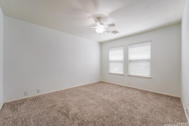 carpeted spare room with ceiling fan