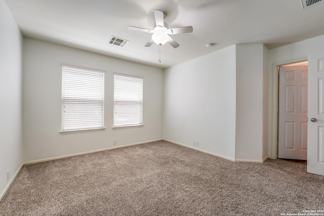 carpeted spare room with ceiling fan