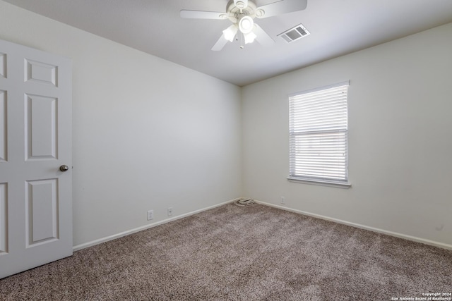 carpeted spare room featuring ceiling fan