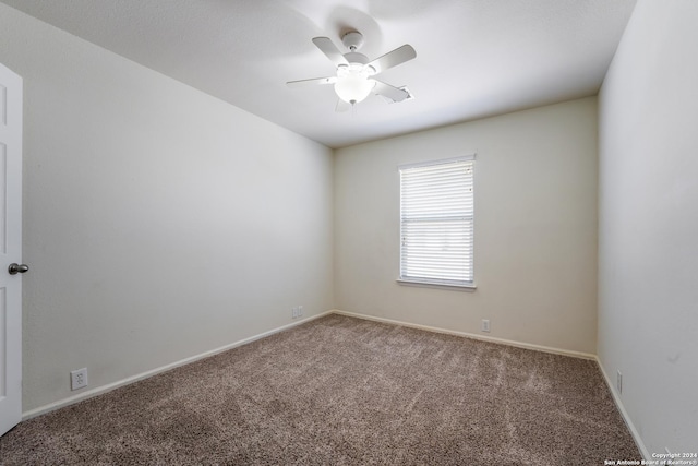 spare room featuring carpet and ceiling fan