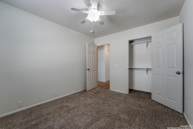 unfurnished bedroom featuring ceiling fan, a closet, and dark carpet