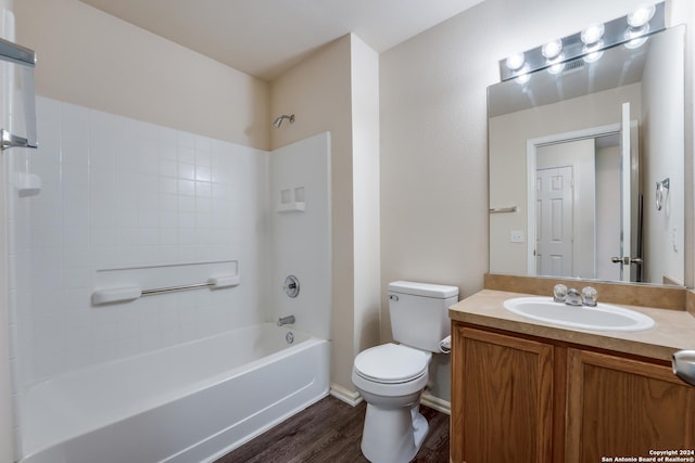 full bathroom with bathing tub / shower combination, toilet, vanity, and hardwood / wood-style flooring