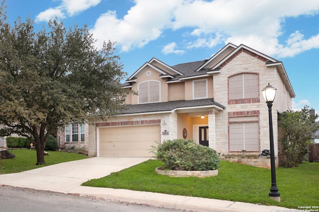 view of front of house with a front yard and a garage