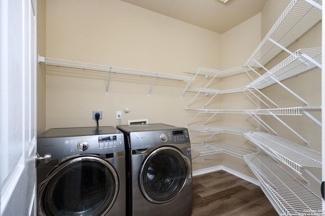 laundry area with separate washer and dryer and wood-type flooring