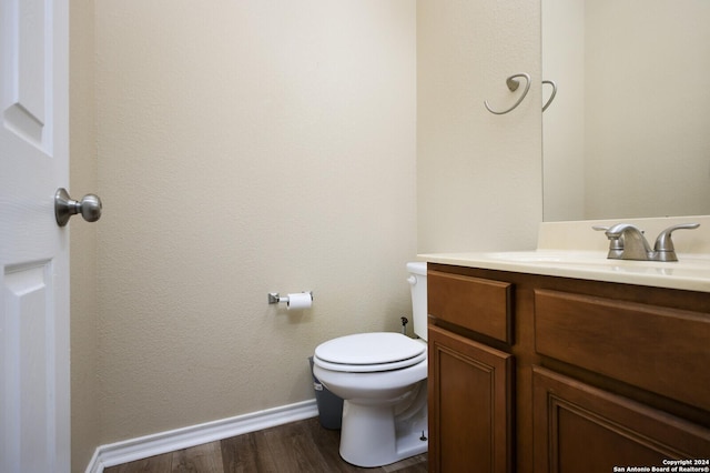 bathroom with vanity, hardwood / wood-style flooring, and toilet