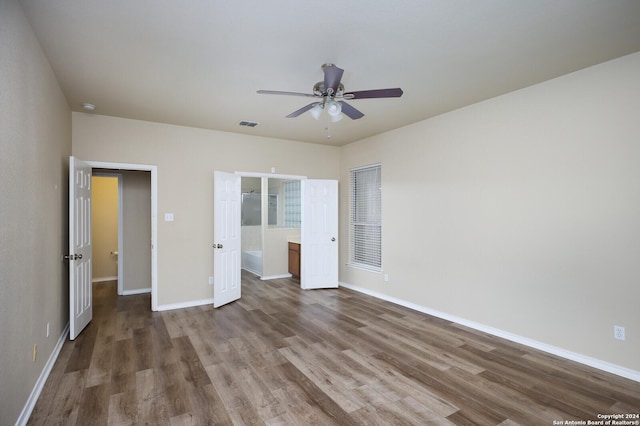 unfurnished bedroom with ceiling fan and hardwood / wood-style flooring