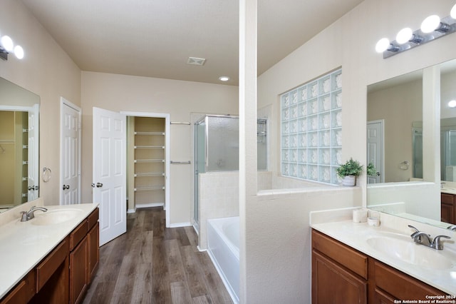 bathroom with plus walk in shower, vanity, and hardwood / wood-style flooring