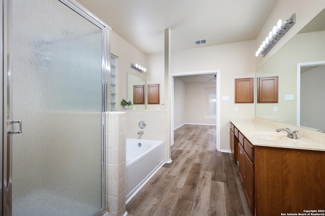 bathroom featuring vanity, shower with separate bathtub, and hardwood / wood-style flooring