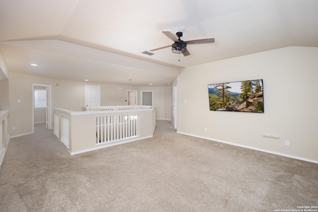 unfurnished living room with ceiling fan, light carpet, and vaulted ceiling