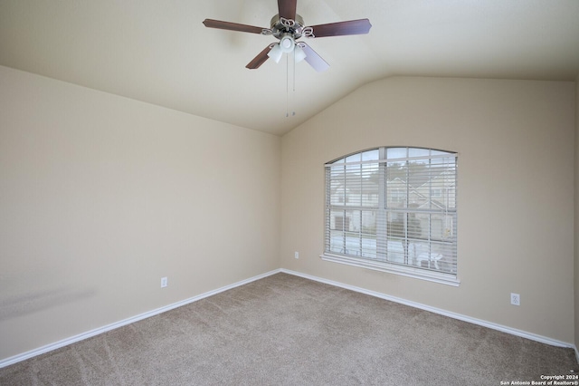 carpeted spare room with ceiling fan and lofted ceiling