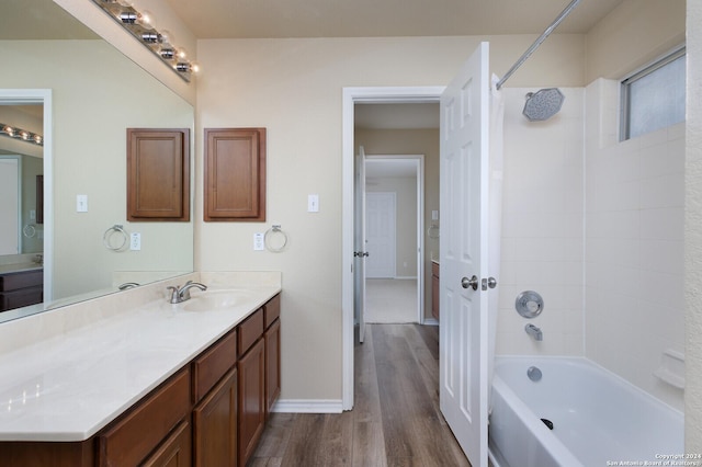 bathroom featuring shower / bath combination, vanity, and wood-type flooring