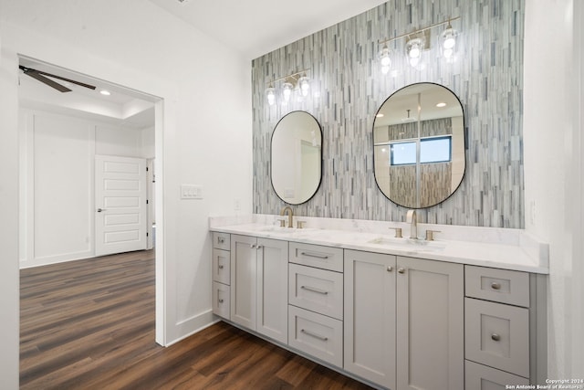 bathroom with hardwood / wood-style floors, vanity, and ceiling fan