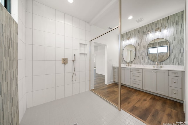 bathroom featuring vanity and tile walls