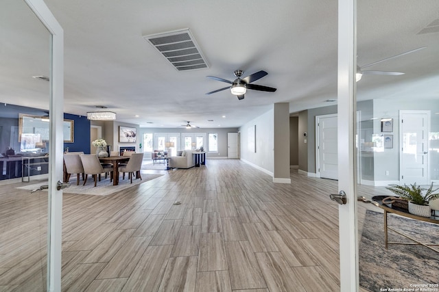 living room with ceiling fan and french doors