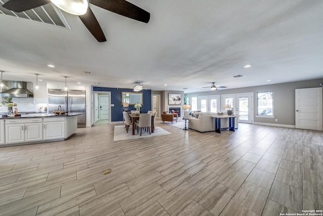 unfurnished living room featuring ceiling fan