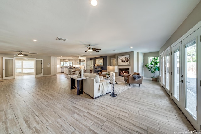 living room featuring french doors and ceiling fan