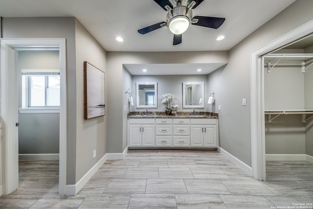 bathroom featuring ceiling fan and vanity