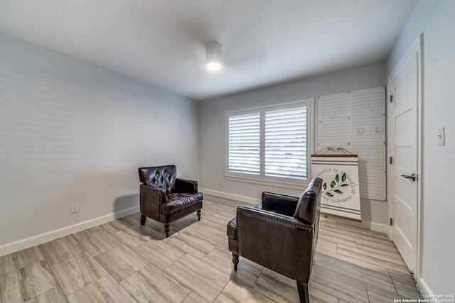 living area with ceiling fan