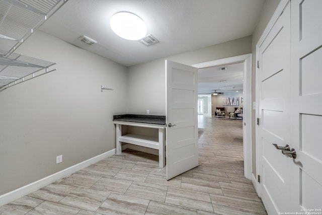 interior space with ceiling fan