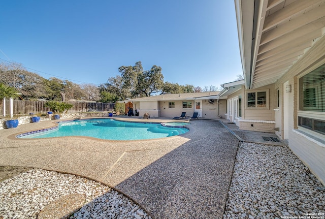 view of swimming pool with a patio area and an in ground hot tub