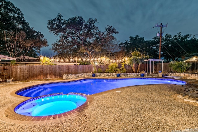 view of swimming pool featuring an in ground hot tub