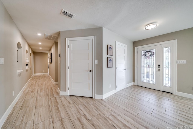 entryway with a textured ceiling