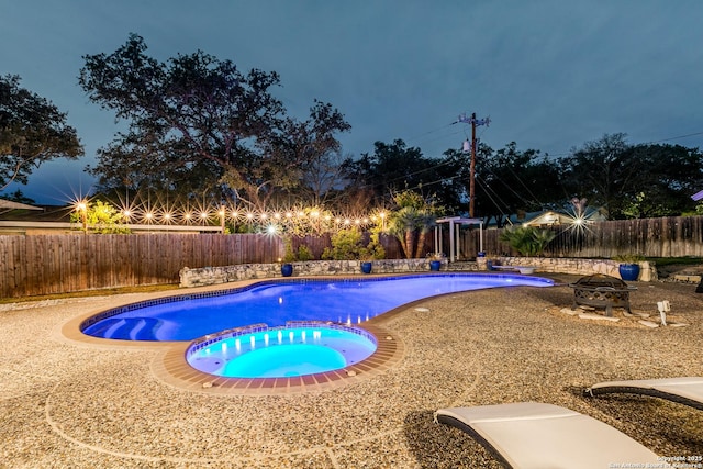 view of pool with an in ground hot tub and a fire pit