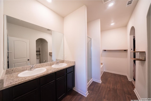 full bathroom with separate shower and tub, vanity, toilet, and hardwood / wood-style flooring