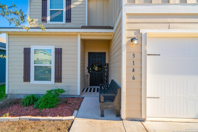 doorway to property with a garage