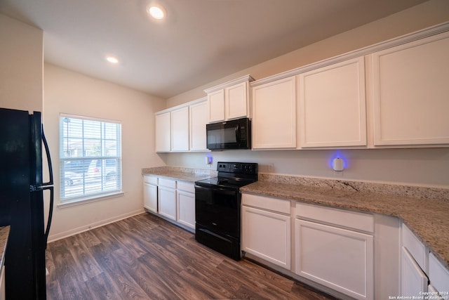 kitchen with black appliances, dark hardwood / wood-style floors, light stone counters, and white cabinetry