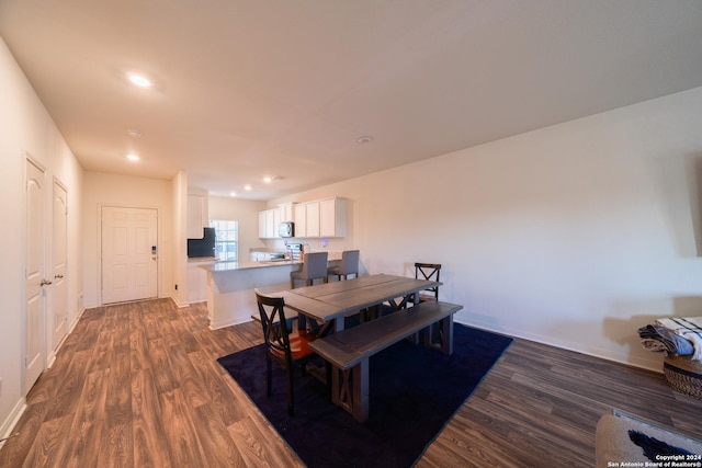 dining space with dark hardwood / wood-style floors