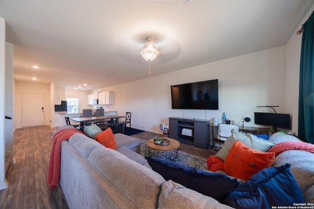 living room featuring ceiling fan and wood-type flooring