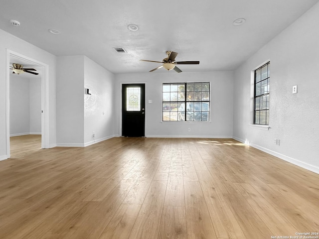 interior space with ceiling fan and light hardwood / wood-style floors