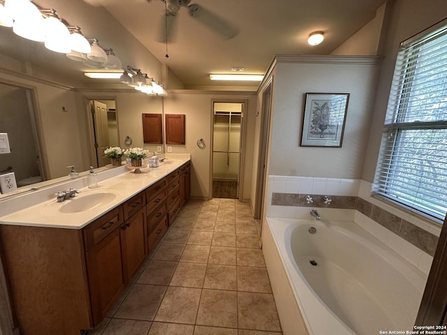 bathroom featuring tile patterned flooring, vanity, ceiling fan, and a washtub