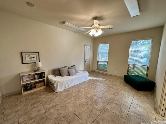 bedroom featuring light tile patterned floors and ceiling fan