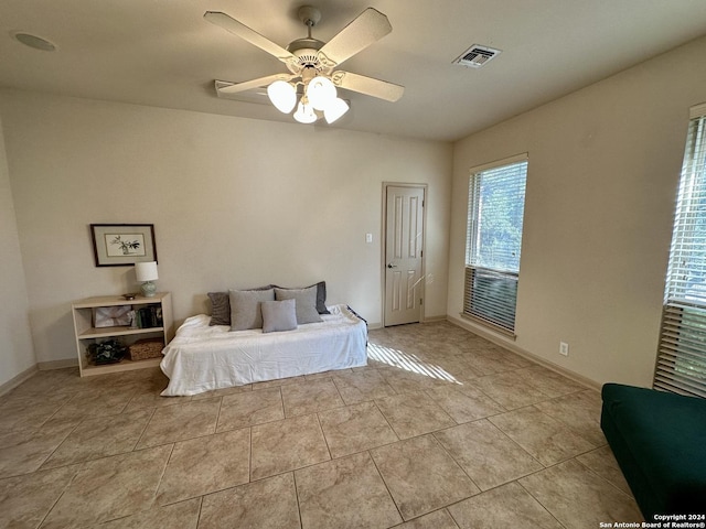 tiled bedroom with ceiling fan