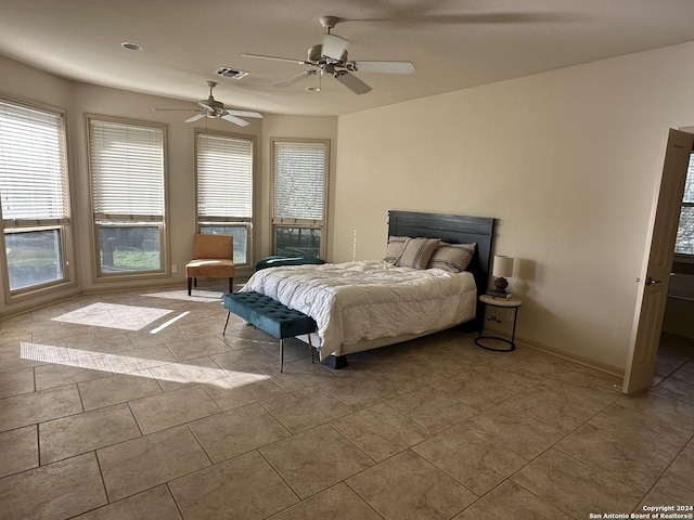 tiled bedroom featuring ceiling fan