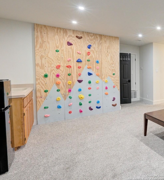 game room featuring light colored carpet