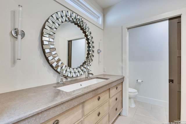 bathroom with tile patterned floors, vanity, and toilet