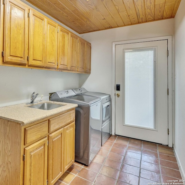 washroom with cabinets, washer and clothes dryer, sink, light tile patterned floors, and wooden ceiling