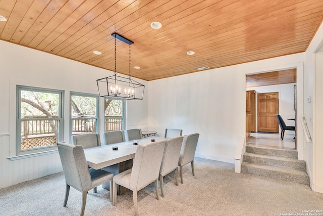 dining space featuring a chandelier and wooden ceiling